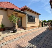 A family house in Čakajovce with a landscaped yard and parking space in front of the entrance.