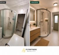 Bathroom of a 2-room apartment with a shower corner and a floor with a wooden decor.