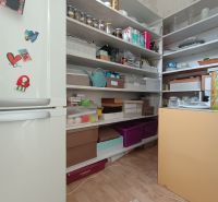 Storage room with shelves for groceries and kitchen supplies in a 4-room apartment.