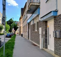 Daniel Dlabač Street in Žilina with an exterior view of the building and a green lawn.