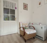 A corner with a wicker chair and a floor with a wooden decor in a 4-room apartment.