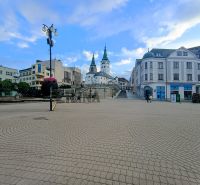 The center of Žilina on Daniela Dlabača Street with historical architecture and a cobblestone square.