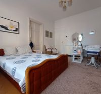 Bedroom in a 4-room apartment with carpet and furniture, floor with wooden decor.