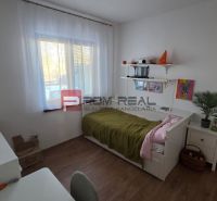 Children's room in a family house with a bed, a desk, and a wooden decor floor.