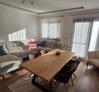 Living room of a family house with a corner sofa and a dining table.
