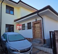 Family house on Pri Vápenickom potoku Street in Bratislava IV with a car in the parking lot.