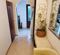 A hallway in a 4-room apartment with arched passages and decorated walls.