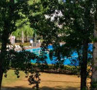 A summer pool surrounded by greenery on Hradná Street in Komárno.