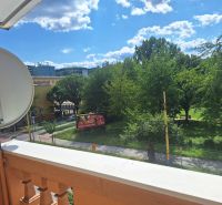 View of greenery and 17. novembra Street in Prešov from a 2-room apartment.