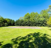 Garden with a lawn area and trees on a residential plot in Limbach on Krátka Street.