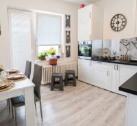 The family house has a bright kitchen with a dining table and decorations.