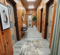 Interior of a family house with walls made of wooden panels and a floor with a wooden decor.