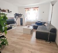 Living room in a family house with a wooden decor floor and a comfortable sofa.