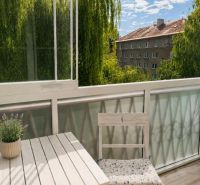 A glazed balcony with a view of greenery in a 2-room apartment on 29. Augusta in Banská Bystrica.