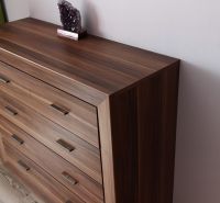 A dresser with a wooden floor decor in a studio apartment.