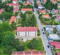 Aerial view of residential buildings and greenery on Dimitrov Street in Handlová.