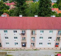 Apartment building on Dimitrov Street in Handlová, surrounded by greenery and family houses.