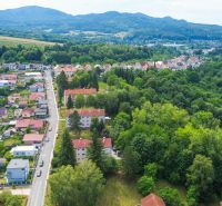 An aerial view of Dimitrovova Street in Handlová with nature in the background.