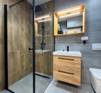 Stylish bathroom with a shower and a cabinet with a wooden decor.