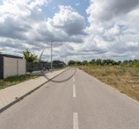 The road on Brezová Street in Zohor, surrounded by residential plots and greenery.