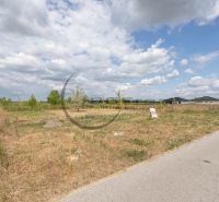 A residential plot on Brezová Street in Zohor, with a view of the surrounding houses.