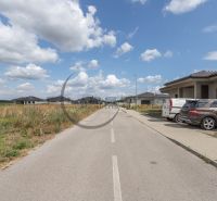 The road on Brezová Street in Zohor, surrounded by new buildings and residential plots.