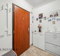 Entrance hall in a 3-room apartment with a coat rack and decorations on the walls.