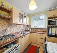 A kitchen with a gas stove and decorative ceramic items in a 3-room apartment.