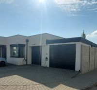 A family house on Rizlingova Street in Trenčín with a built-in garage and a car.