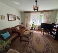 Living room in a family house with a wooden decor floor and a sofa.