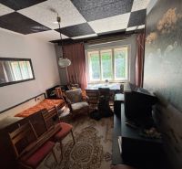 A room with carpet decor and a television in a family house.