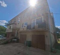 A family house with a garage on a sunny day.
