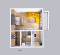 Floor plan of a 1-room apartment with wood-patterned flooring and a yellow sofa.