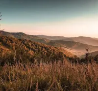 Autumn landscape of agricultural and forest lands in Dohňany, golden hills and grass.