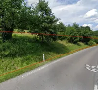 A green slope with a road in Orovnica, part of a unique property.