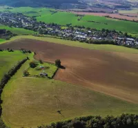 Agricultural and forest lands around the village of Trenčianske Stankovce with extensive fields.