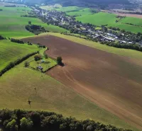 Greenery and arable land surround the village of Trenčianske Stankovce, emphasizing agricultural and forest land.