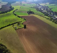 Agricultural and forest land around Trenčianske Stankovce, with an extensive view of the countryside.