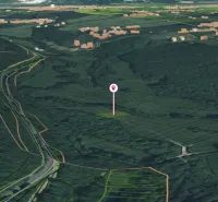 Aerial view of gardens in Horná Ves surrounded by forested and agricultural land.