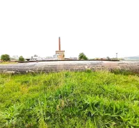 Concrete structure amidst greenery in front of industrial architecture in Malacky in the category of Unique Properties.