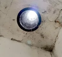A ceiling opening with incoming light in Strange Properties, Malacky.