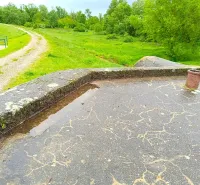 Unusual properties in Malacky, detail of a concrete area with a view of the green terrain.