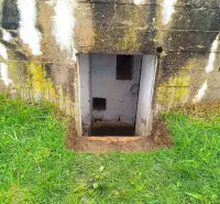 Unusual properties in Malacky with grassy vegetation and a small entrance in the wall.