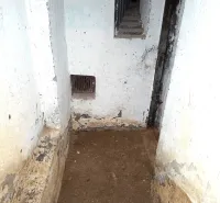 Underground corridor in Special Properties with clear signs of wear and old walls.