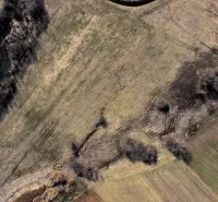 Aerial view of agricultural and forest lands in Podhorany with diverse soil textures.