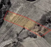 Aerial view of agricultural and forest land in Podhorany with marked area.