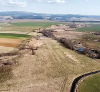 Agricultural and forest lands in Podhorany, with a rich landscape and breathtaking views of the hills.