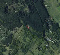 An aerial view of extensive forests and scattered plots around Krupina.