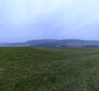 A landscape with green meadows and distant hills around Podkylava, Unusual properties.