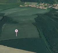 Agricultural and forest lands in Trebušovce, surrounded by fields and wooded areas.